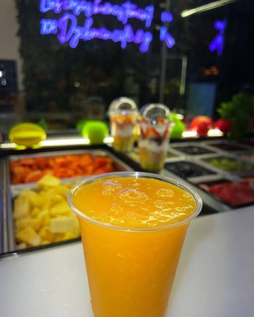 Fresh orange juice in front of the fruit bar